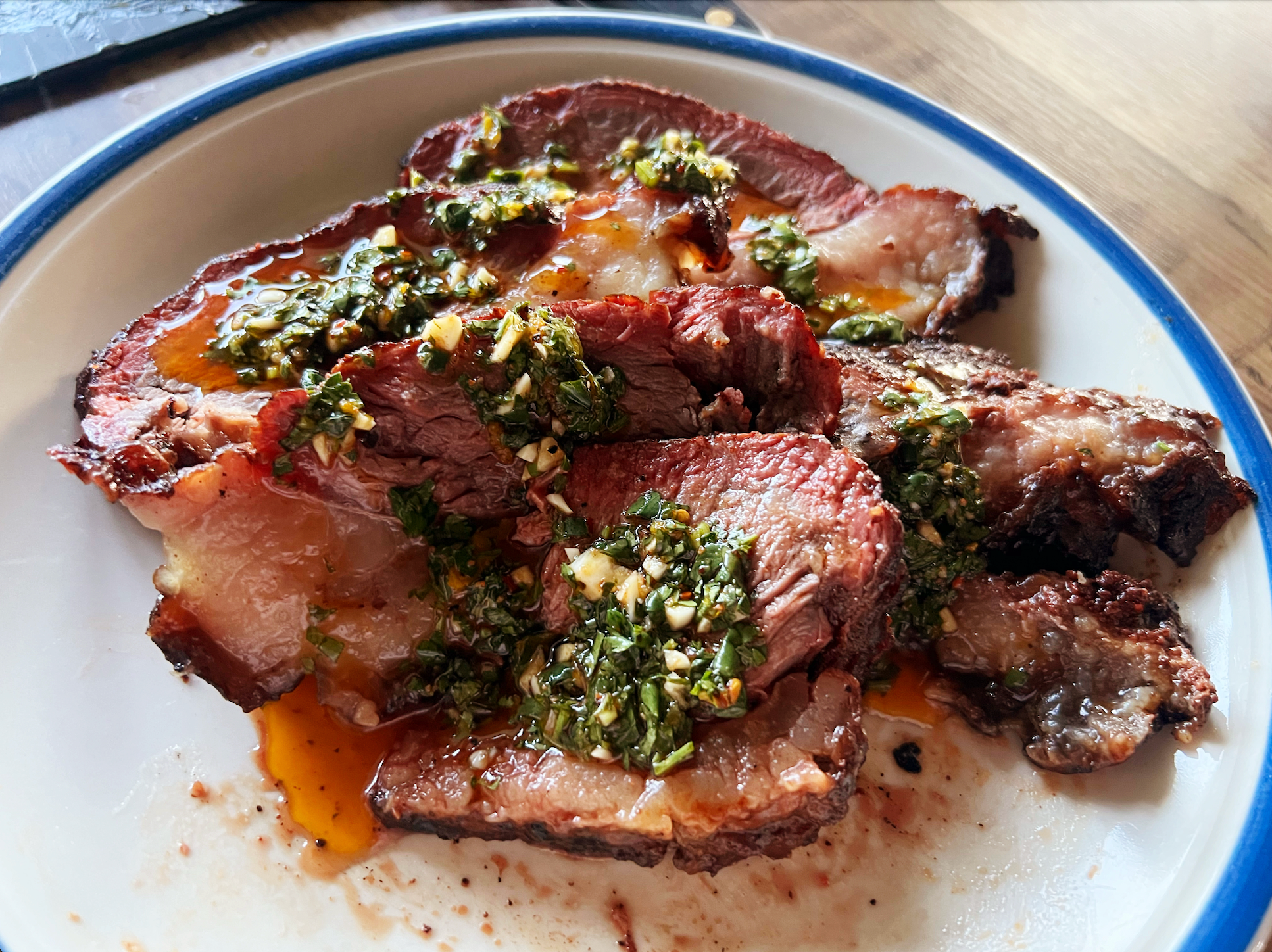 Seared beef with chimichurri on a plate