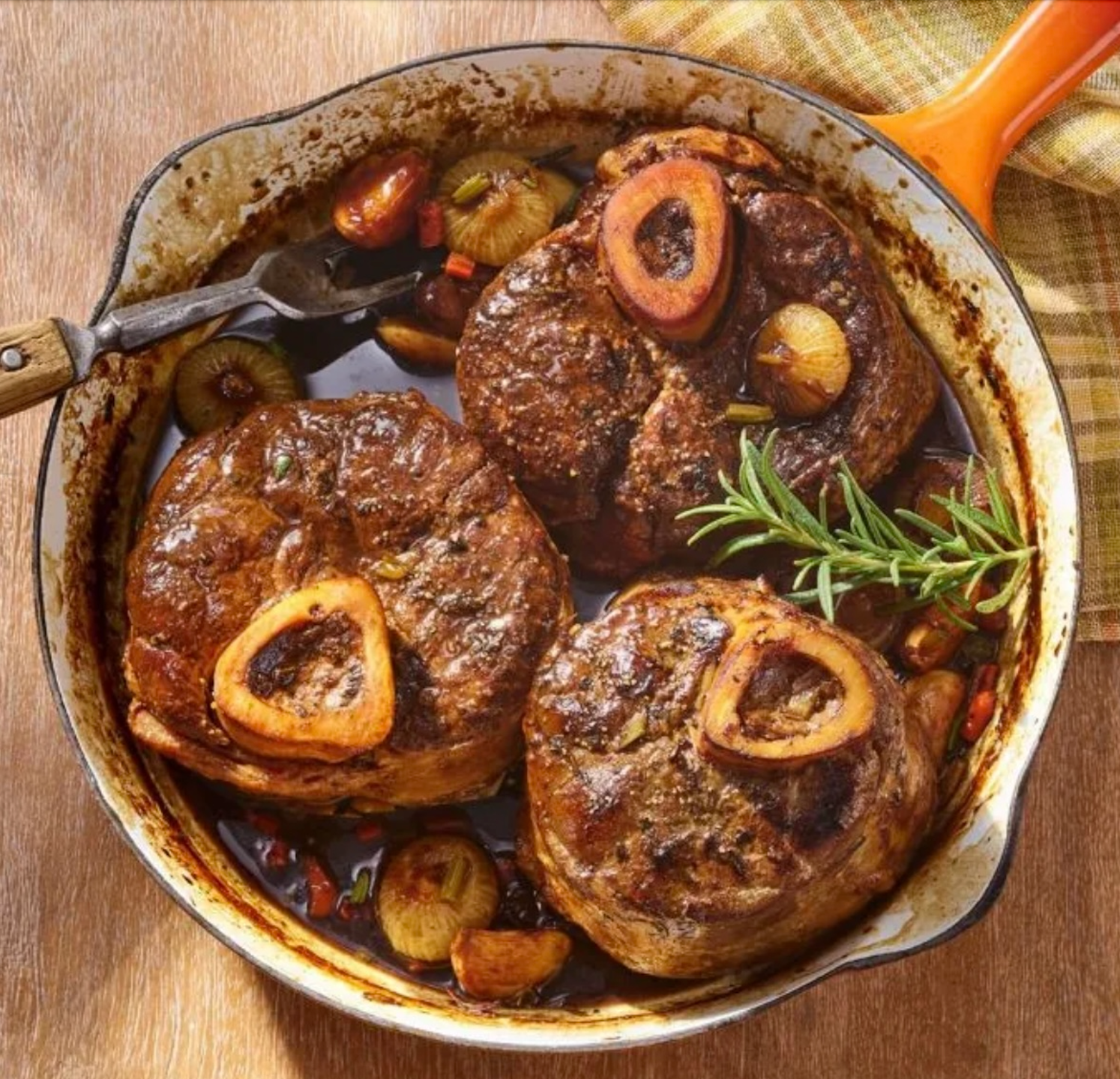 Braised beef osso buco in a cast-iron skillet